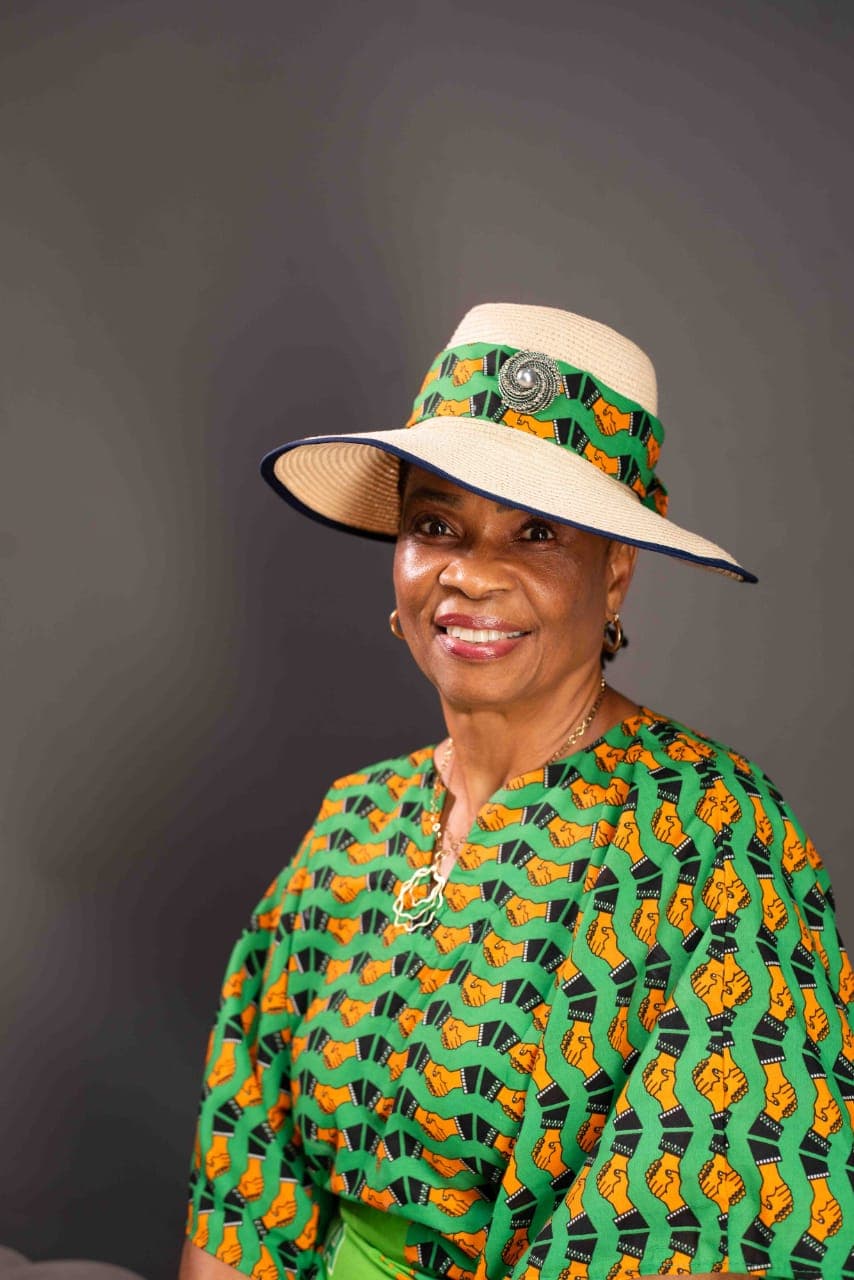 Ambassador Nkoyo Esu Toyo in a straw hat and a green ADC-print outfit, smiling